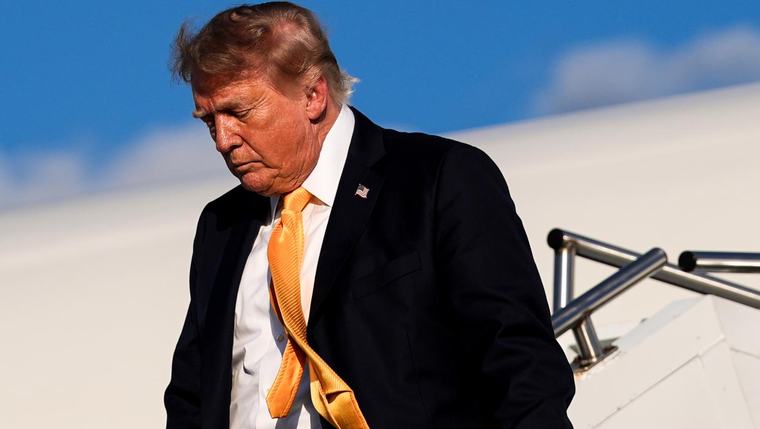Photos show Trump emerging from Air Force One ... wait a minute, his hair is brown!